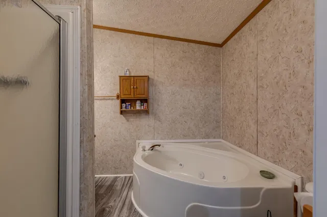a bathroom with a tub and shower