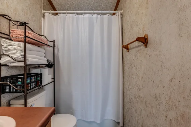 a bathroom with a shower curtain and a sink