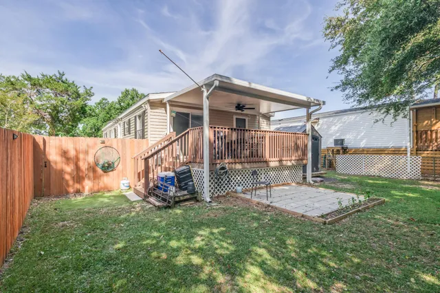 a backyard of a house with table and chairs