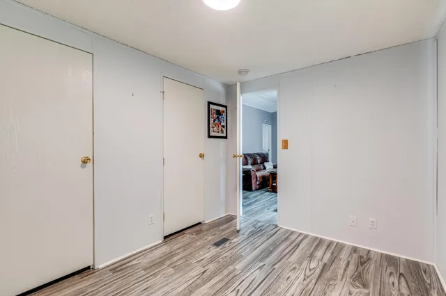 a view of a room with wooden floor and closet
