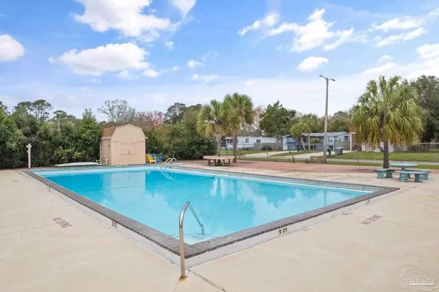 a view of a swimming pool with a yard