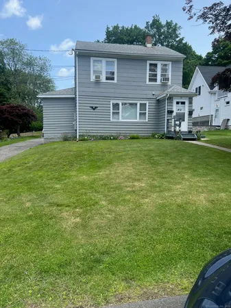 a front view of a house with a garden