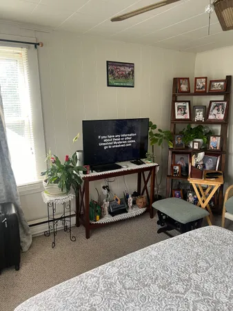 a bedroom with furniture and a window