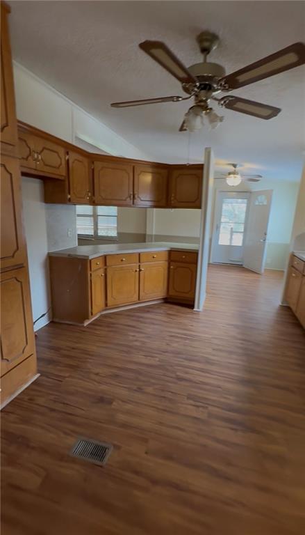 129 Bishop Road Smiths Station, AL 36877 - Photo 11 of 24 Kitchen featuring wood finish cabinetry, dark wood-style floors, and light countertops