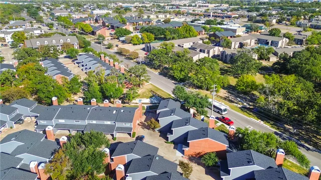 an aerial view of residential houses with outdoor space