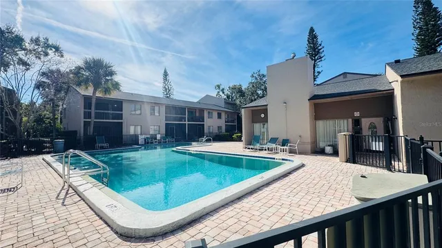 a view of a house with swimming pool and sitting area