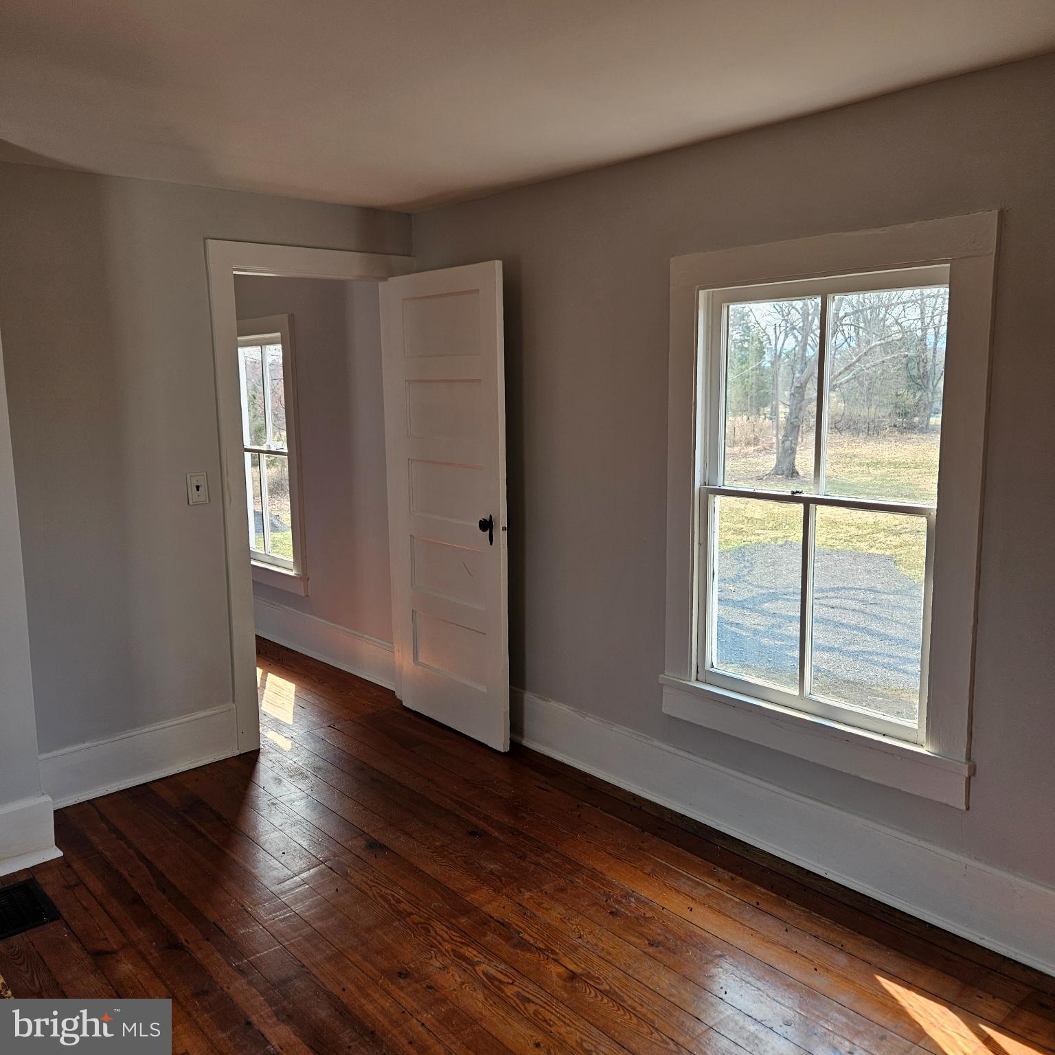 15660 Reva Road Reva, VA 22735 - Photo 38 of 40 a view of an empty room with wooden floor and a window