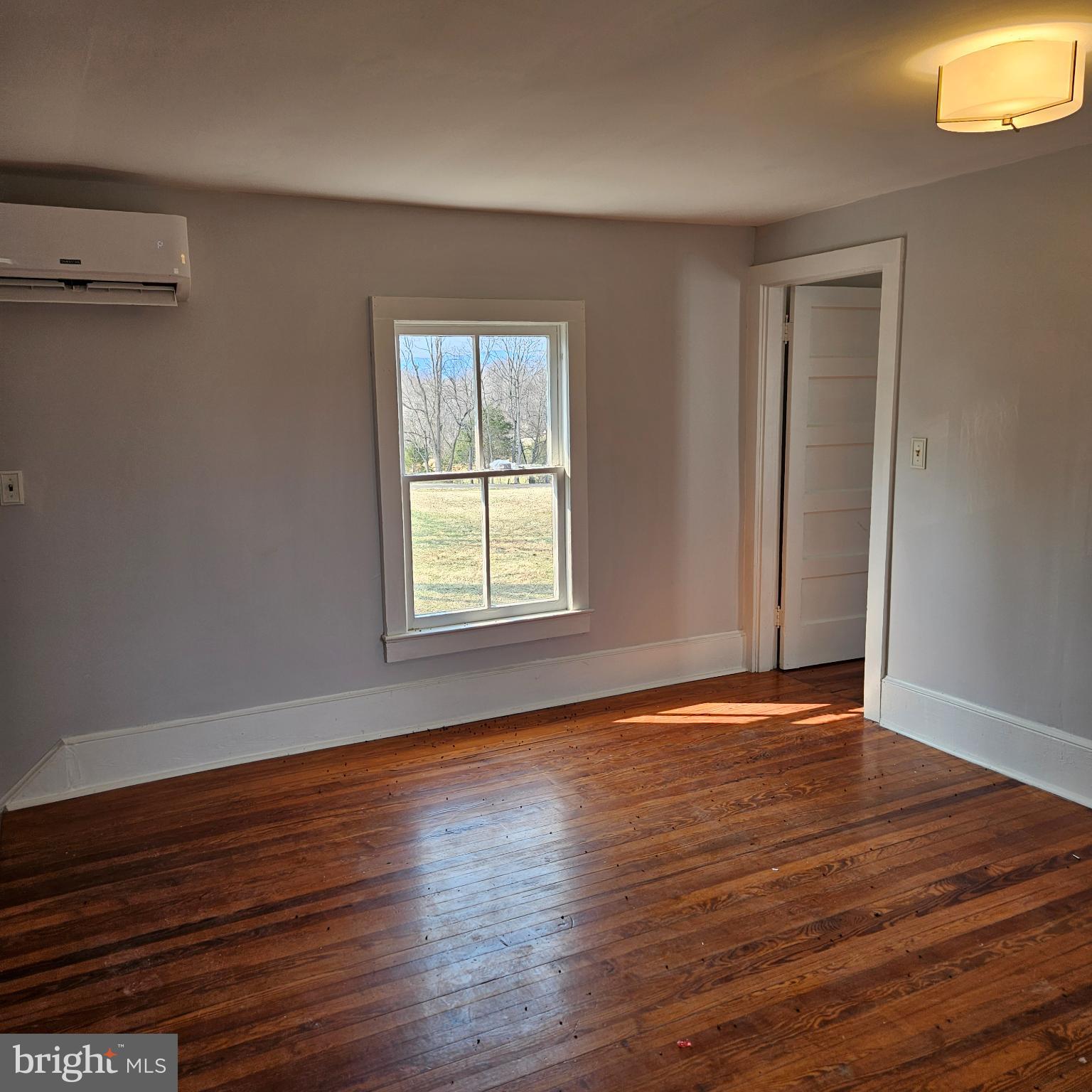 15660 Reva Road Reva, VA 22735 - Photo 39 of 40 a view of an empty room with wooden floor and a window