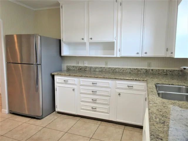 a kitchen with appliances cabinets and a counter top space