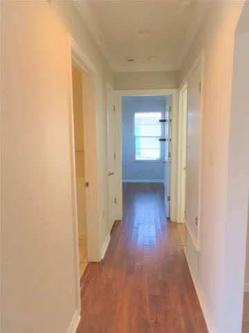 a view of hallway with wooden floor