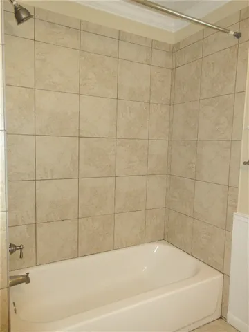 a white bath tub and shower