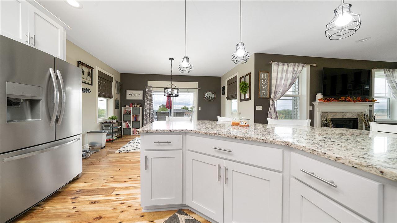 2525 Rogene Drive Oregon, IL 61061 - Photo 17 of 36 a kitchen with stainless steel appliances kitchen island granite countertop a refrigerator a sink dishwasher a oven with white cabinets and wooden floor