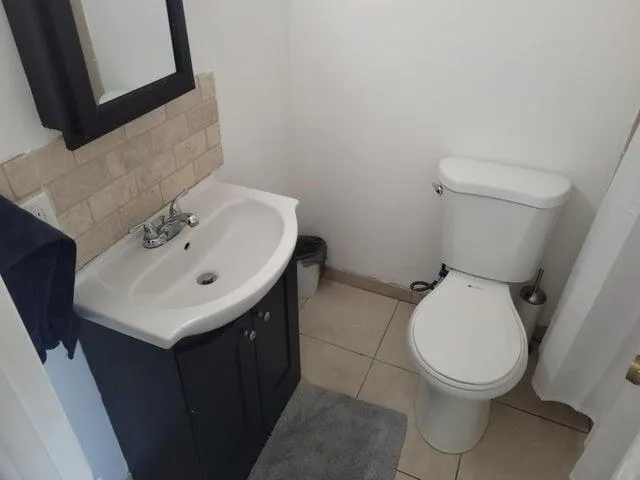 a bathroom with a sink toilet and mirror