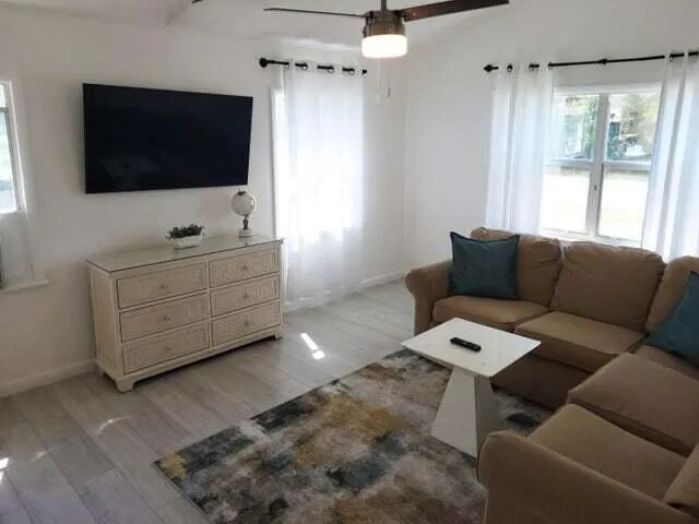 a living room with furniture and a flat screen tv