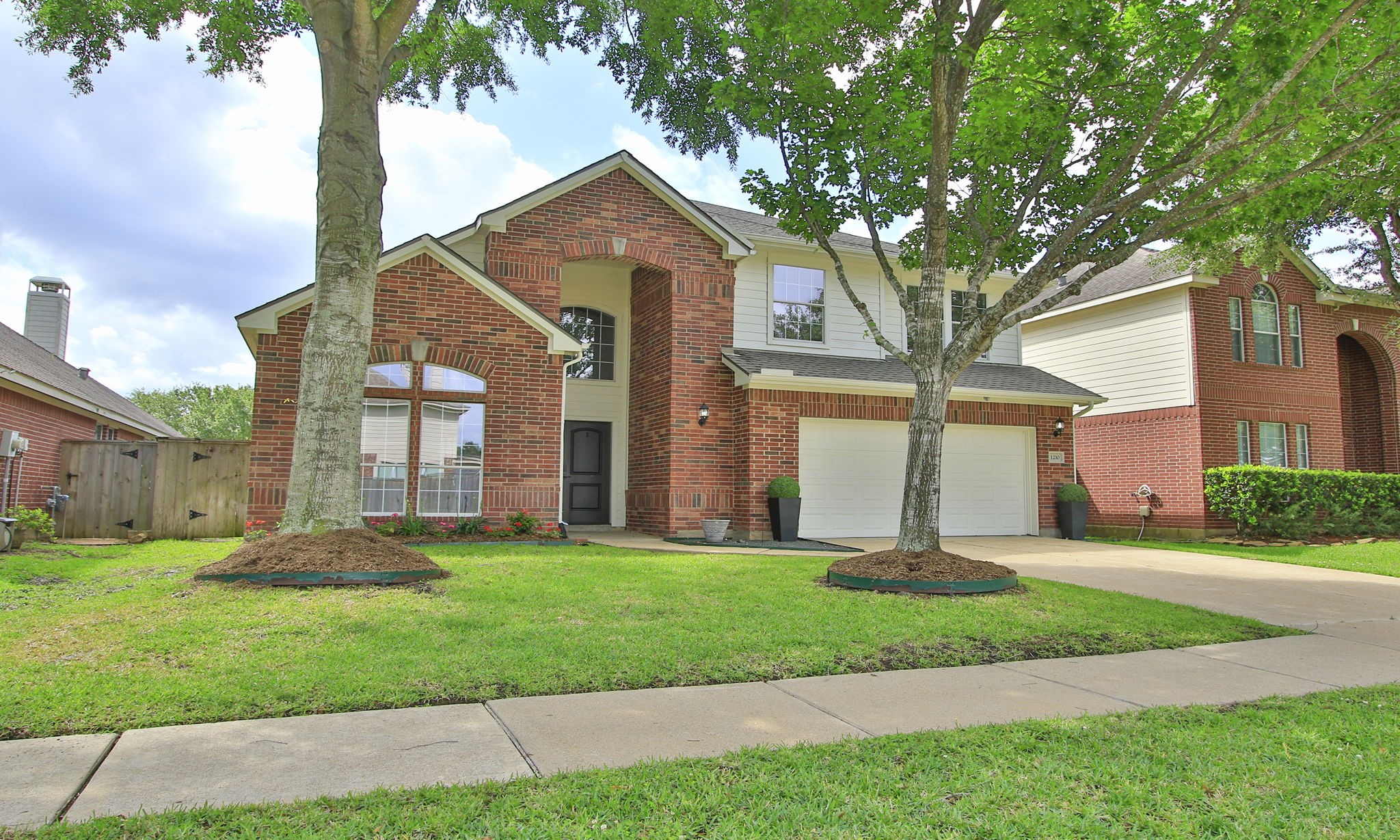 1210 Berwick Manor Court Spring, TX 77379 - Photo 6 of 50 a front view of a house with a yard and an tree