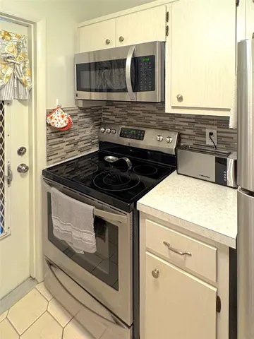a stove top oven sitting inside of a kitchen