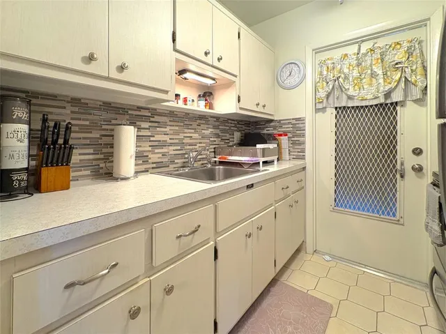a kitchen with stainless steel appliances granite countertop a sink and cabinets