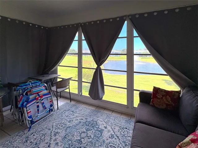 a bedroom with furniture and a large window