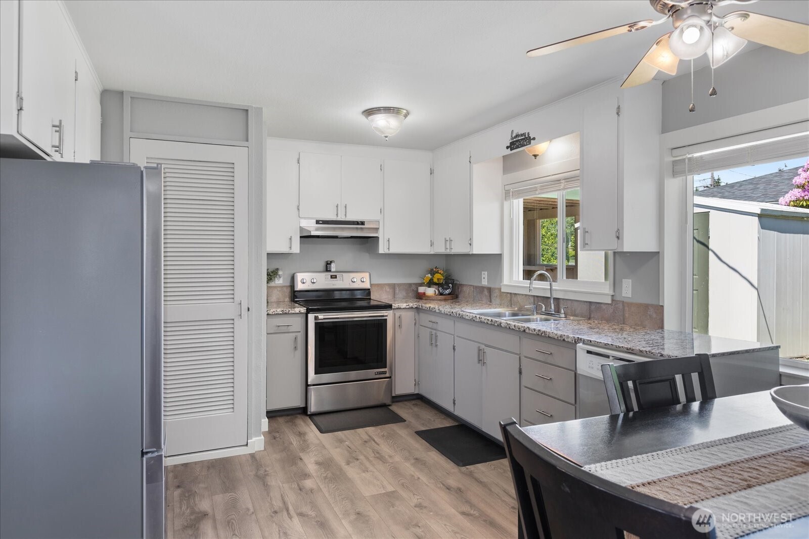 626 Legion Drive Everett, WA 98201 - Photo 18 of 38 a kitchen with granite countertop a sink appliances cabinets and counter space