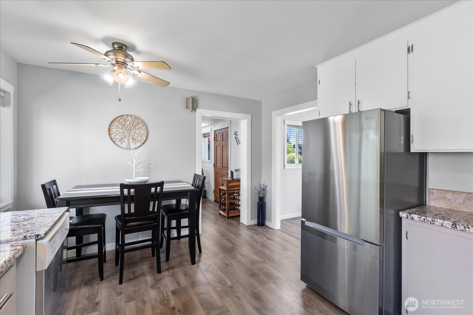 626 Legion Drive Everett, WA 98201 - Photo 19 of 38 a view of a dining room with furniture a chandelier and wooden floor