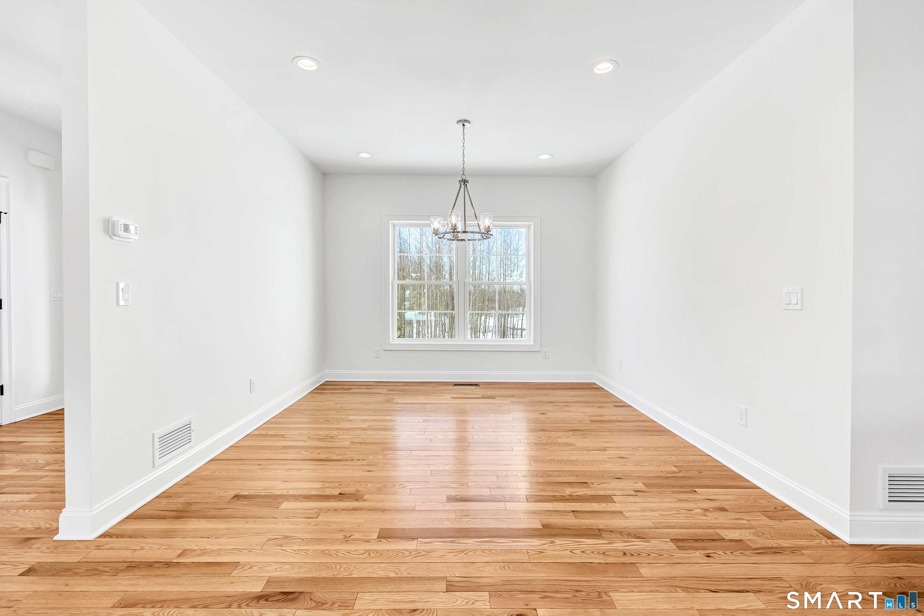15 Hunting Ridge Road Middlebury, CT 06762 - Photo 12 of 38 a view of an empty room with wooden floor and a window