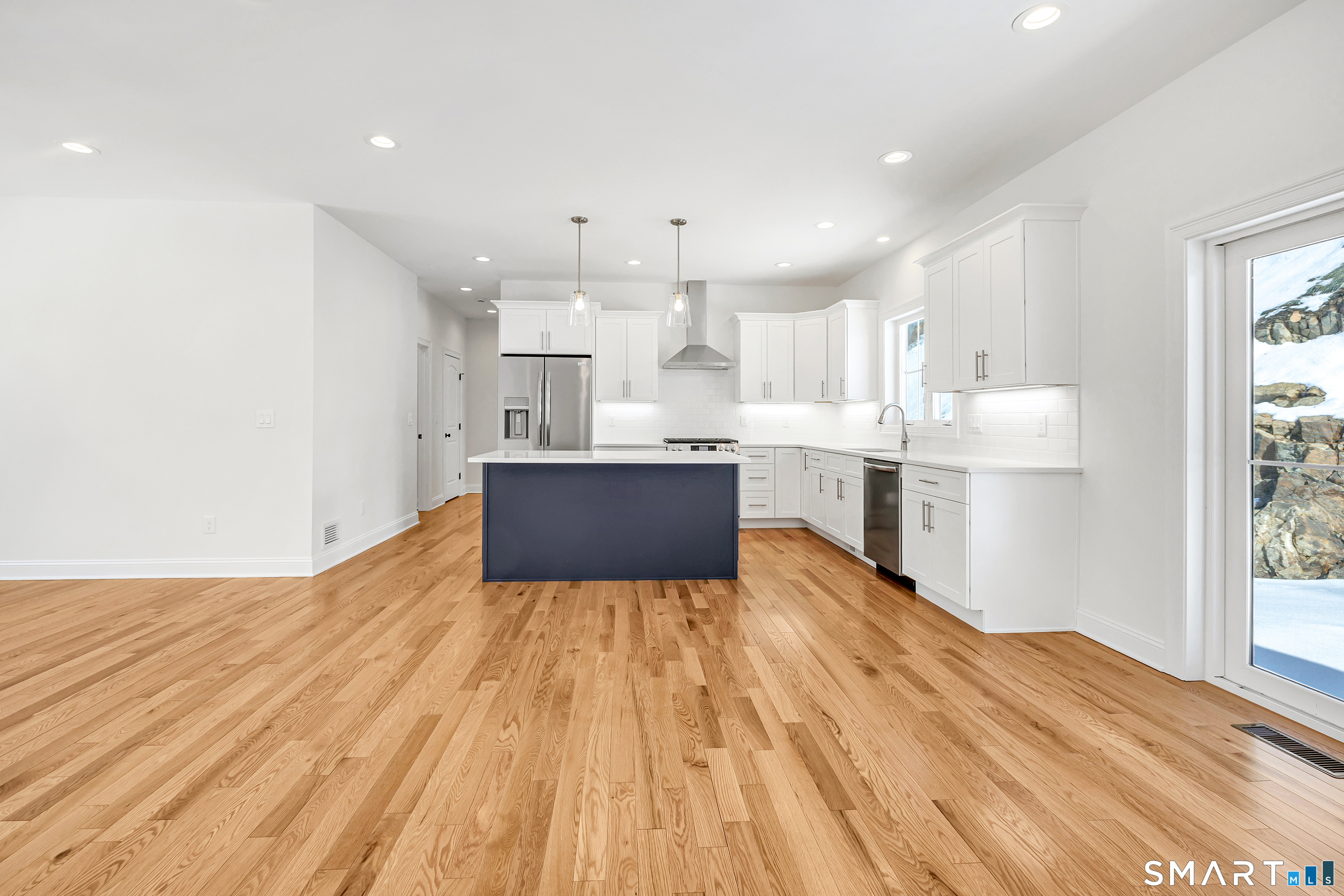15 Hunting Ridge Road Middlebury, CT 06762 - Photo 13 of 41 a living room with stainless steel appliances kitchen island hardwood floor sink and stove