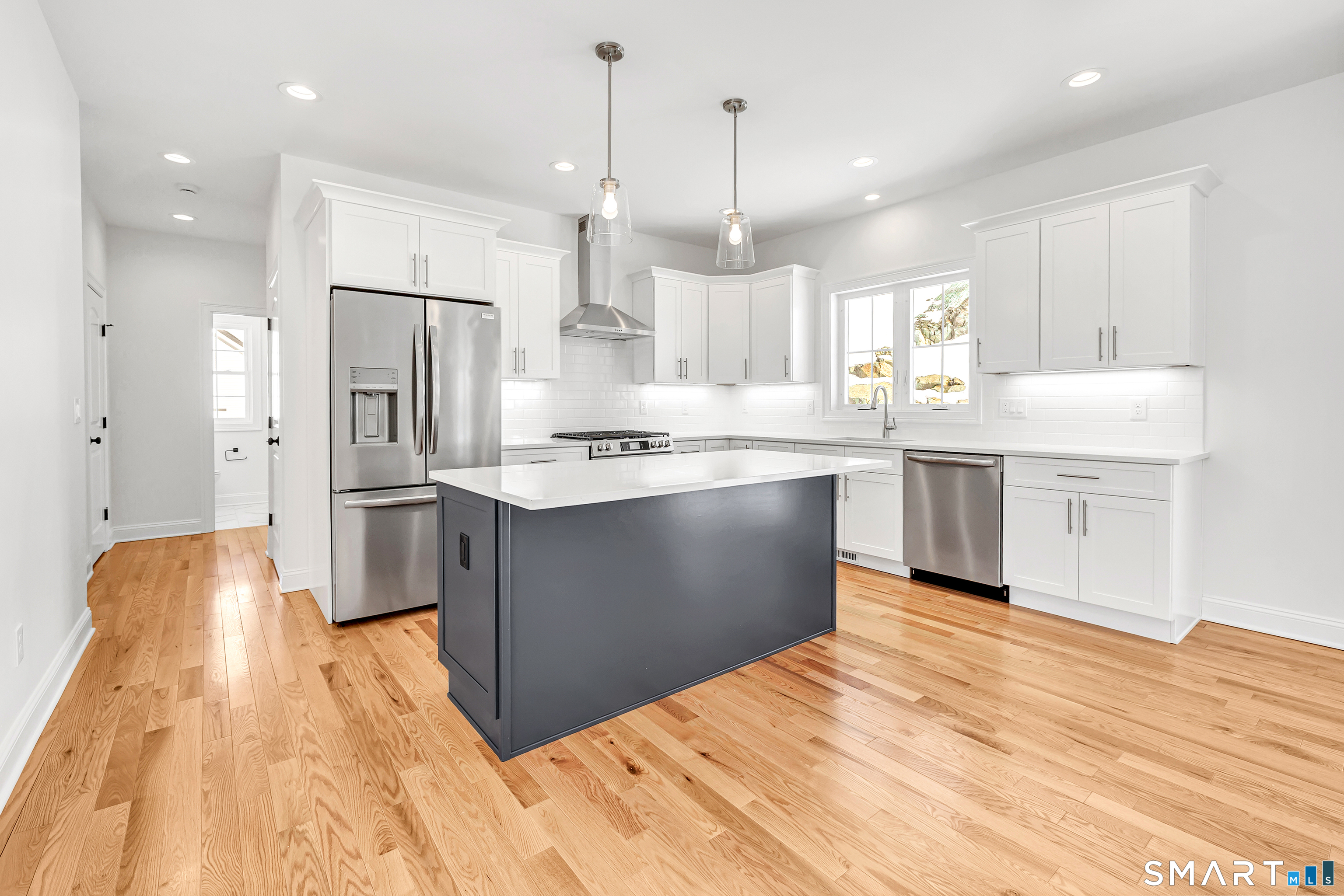 15 Hunting Ridge Road Middlebury, CT 06762 - Photo 18 of 41 a kitchen with stainless steel appliances granite countertop a sink a stove and a refrigerator