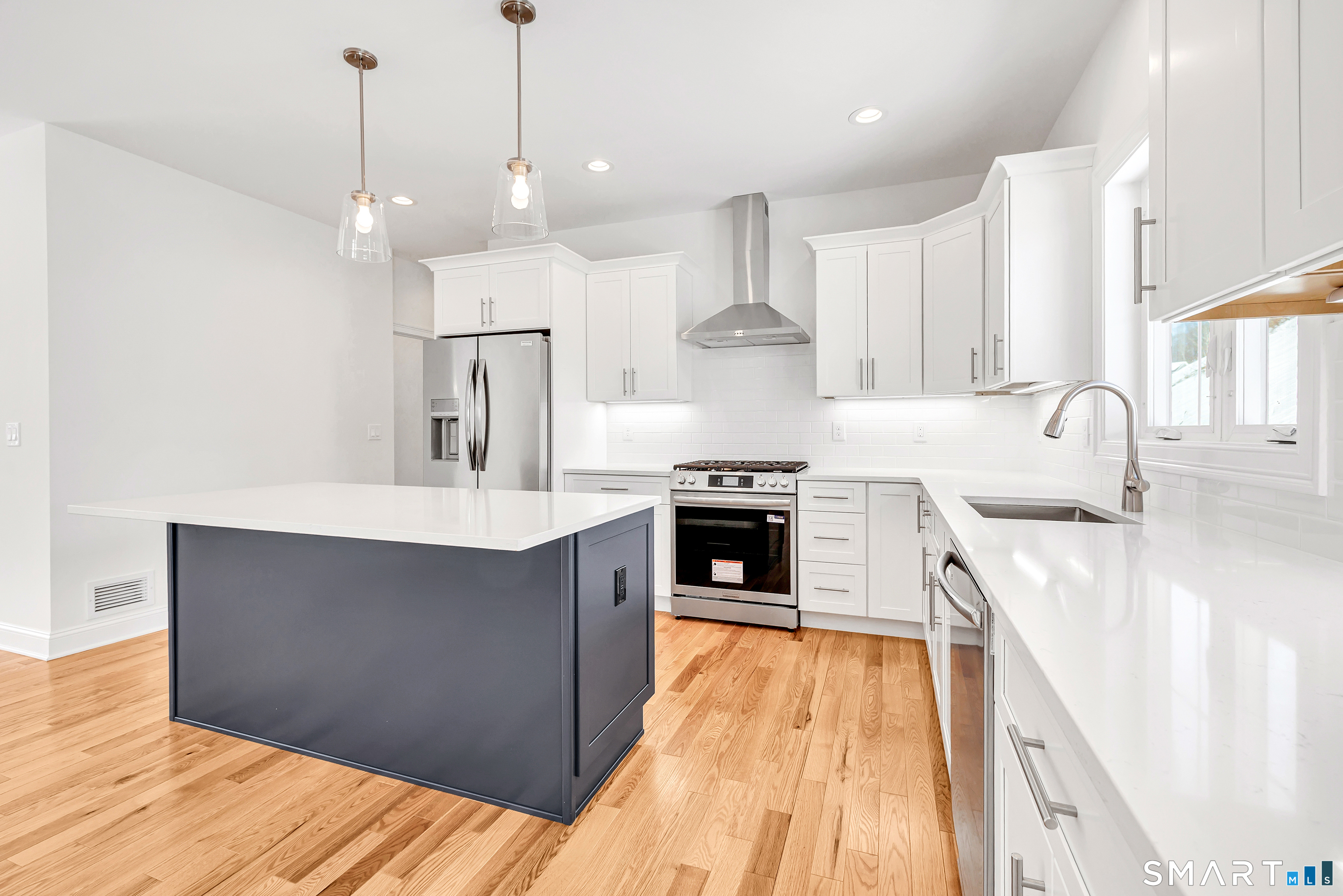 15 Hunting Ridge Road Middlebury, CT 06762 - Photo 19 of 41 a kitchen with stainless steel appliances granite countertop a sink a stove and a wooden floors