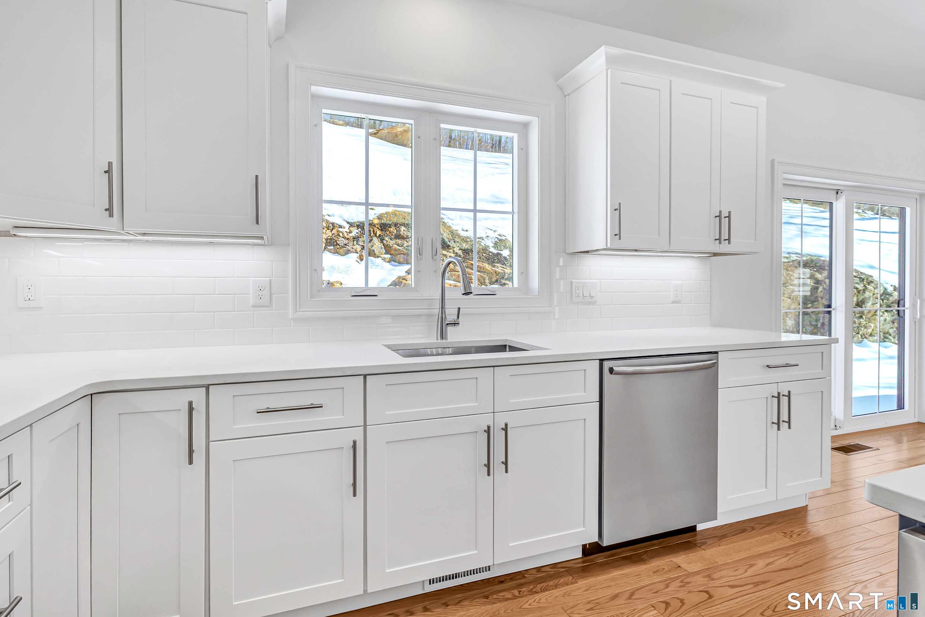 15 Hunting Ridge Road Middlebury, CT 06762 - Photo 20 of 38 a kitchen with white cabinets white appliances and sink