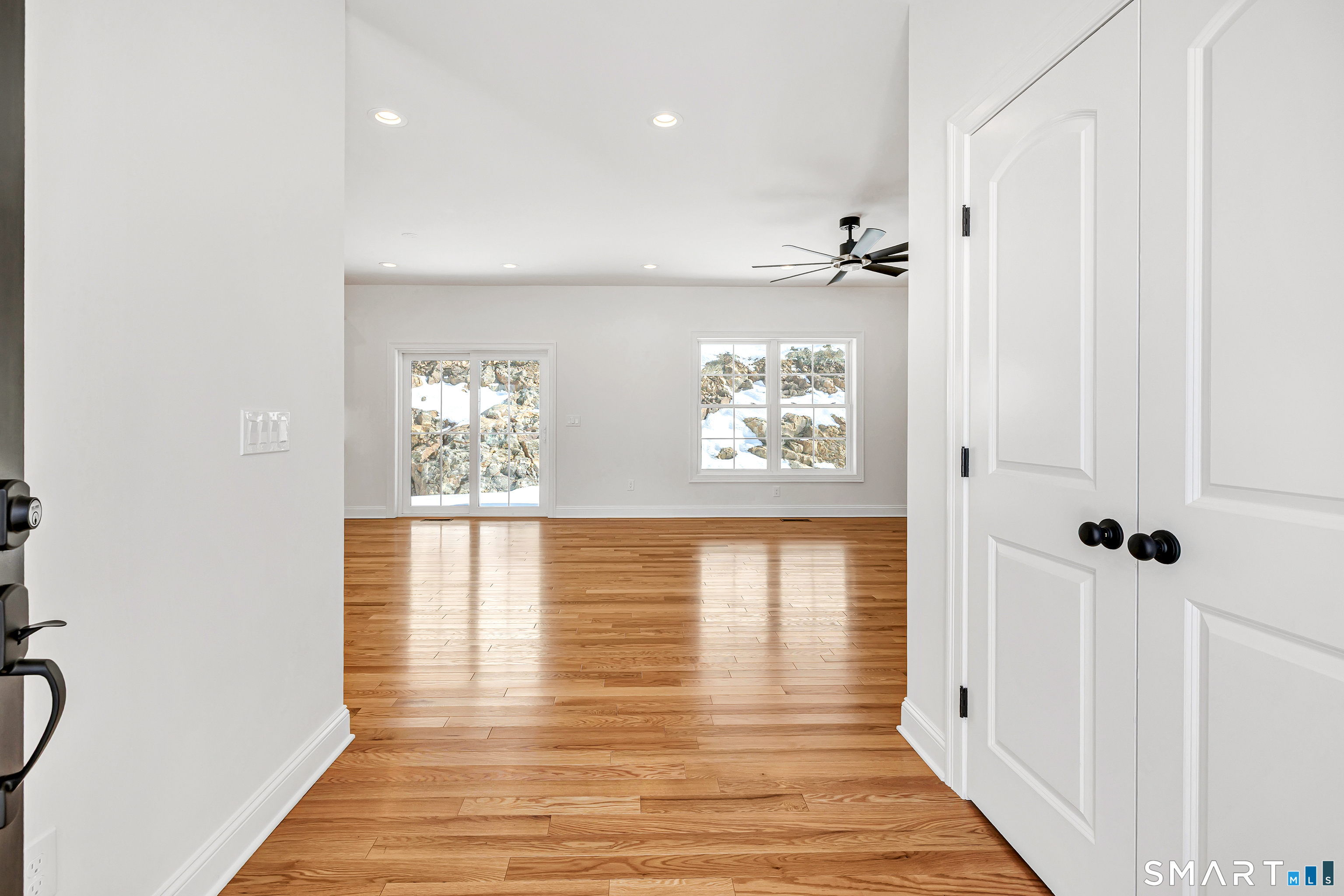 15 Hunting Ridge Road Middlebury, CT 06762 - Photo 2 of 38 a view of a hallway with wooden floor and a bathroom