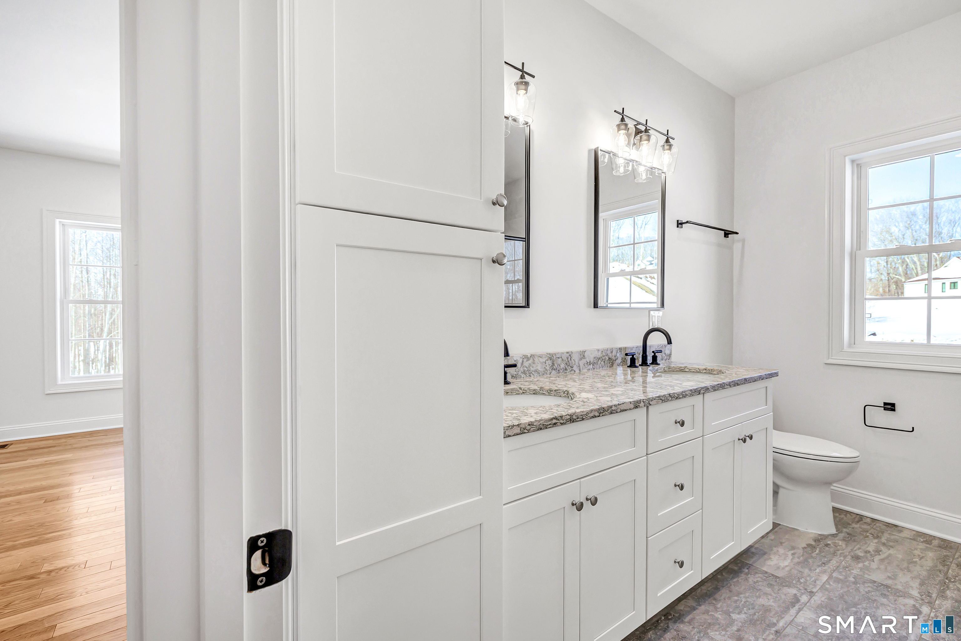 15 Hunting Ridge Road Middlebury, CT 06762 - Photo 21 of 38 a spacious bathroom with a double vanity sink a mirror and a window