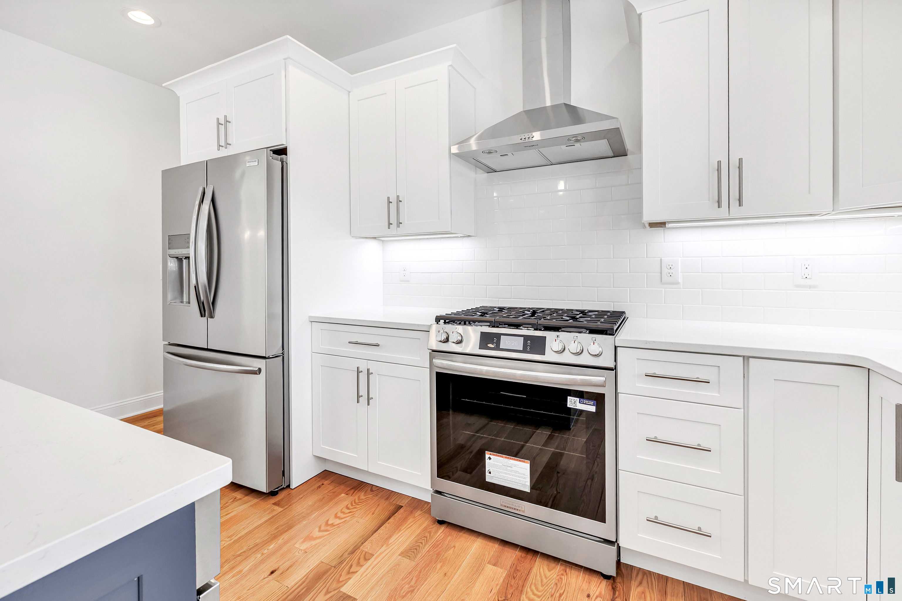 15 Hunting Ridge Road Middlebury, CT 06762 - Photo 22 of 41 a kitchen with stainless steel appliances a stove a refrigerator and cabinets