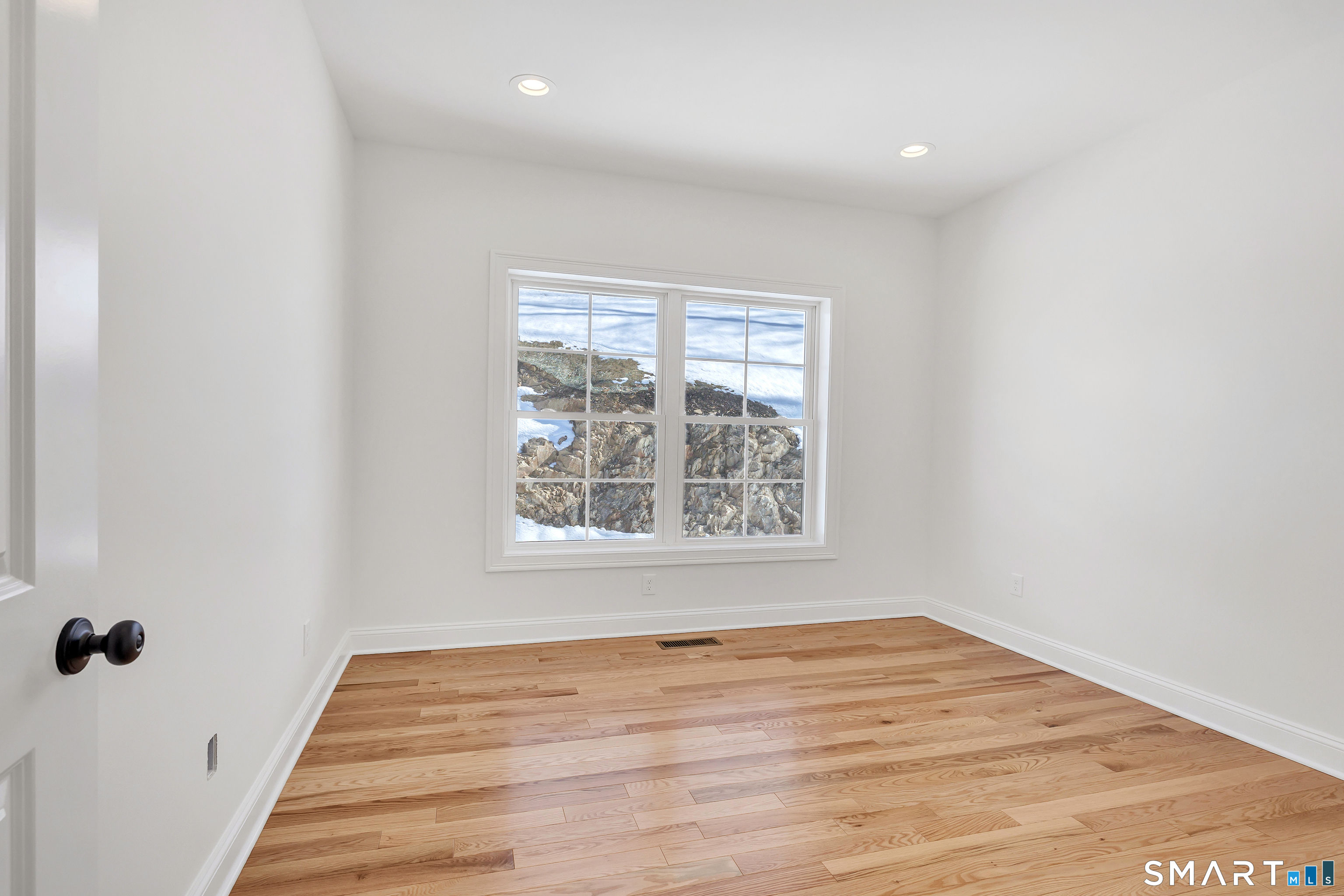 15 Hunting Ridge Road Middlebury, CT 06762 - Photo 33 of 38 an empty room with wooden floor and a window