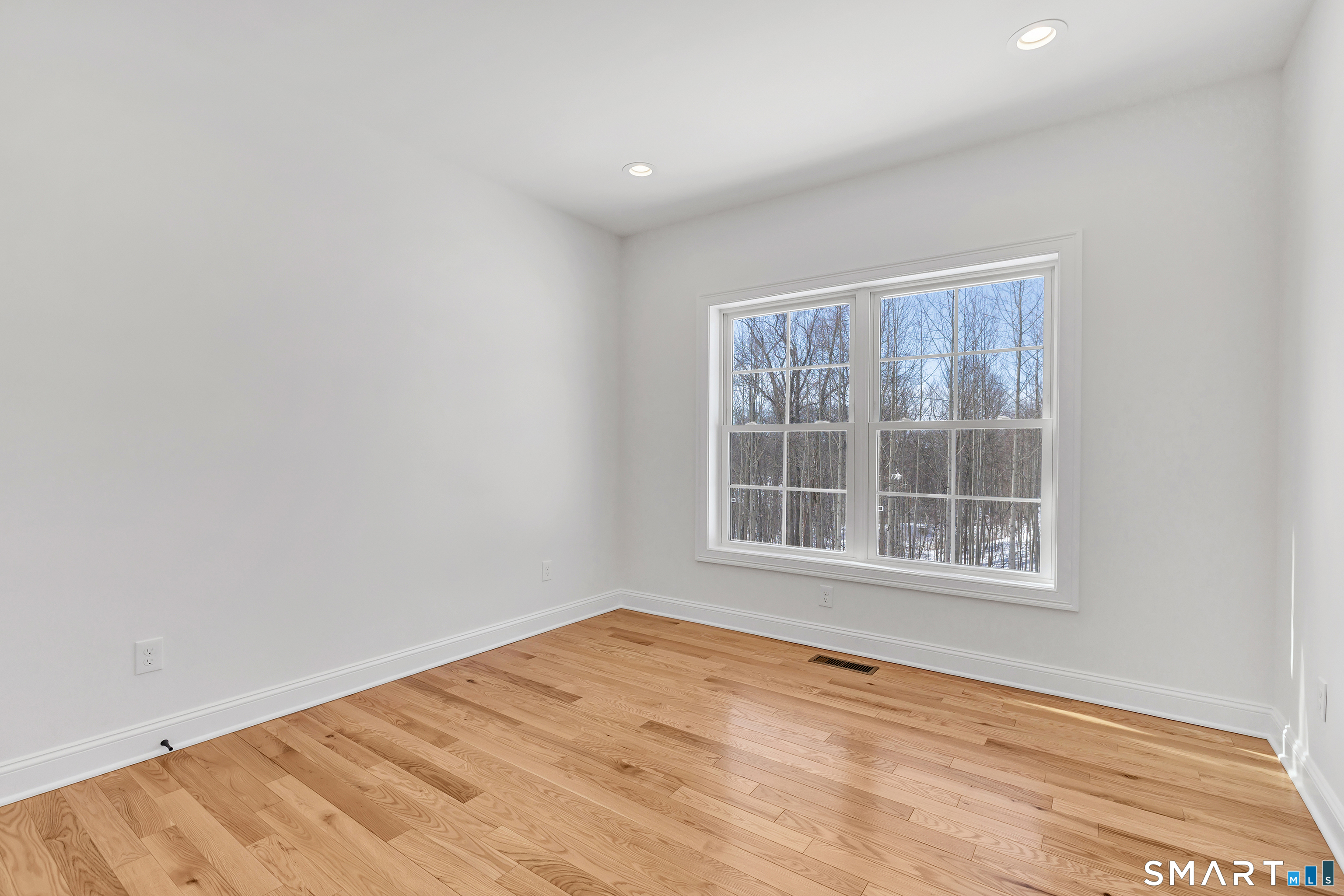 15 Hunting Ridge Road Middlebury, CT 06762 - Photo 41 of 41 an empty room with wooden floor and windows
