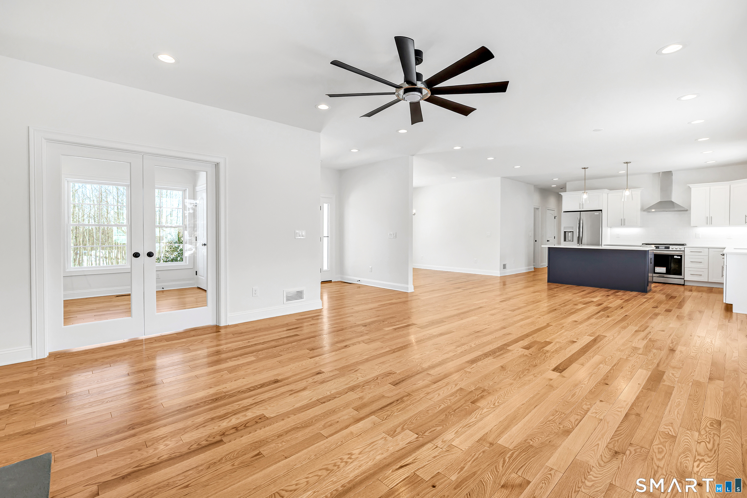 15 Hunting Ridge Road Middlebury, CT 06762 - Photo 5 of 38 a view of a kitchen with wooden floor and a ceiling fan