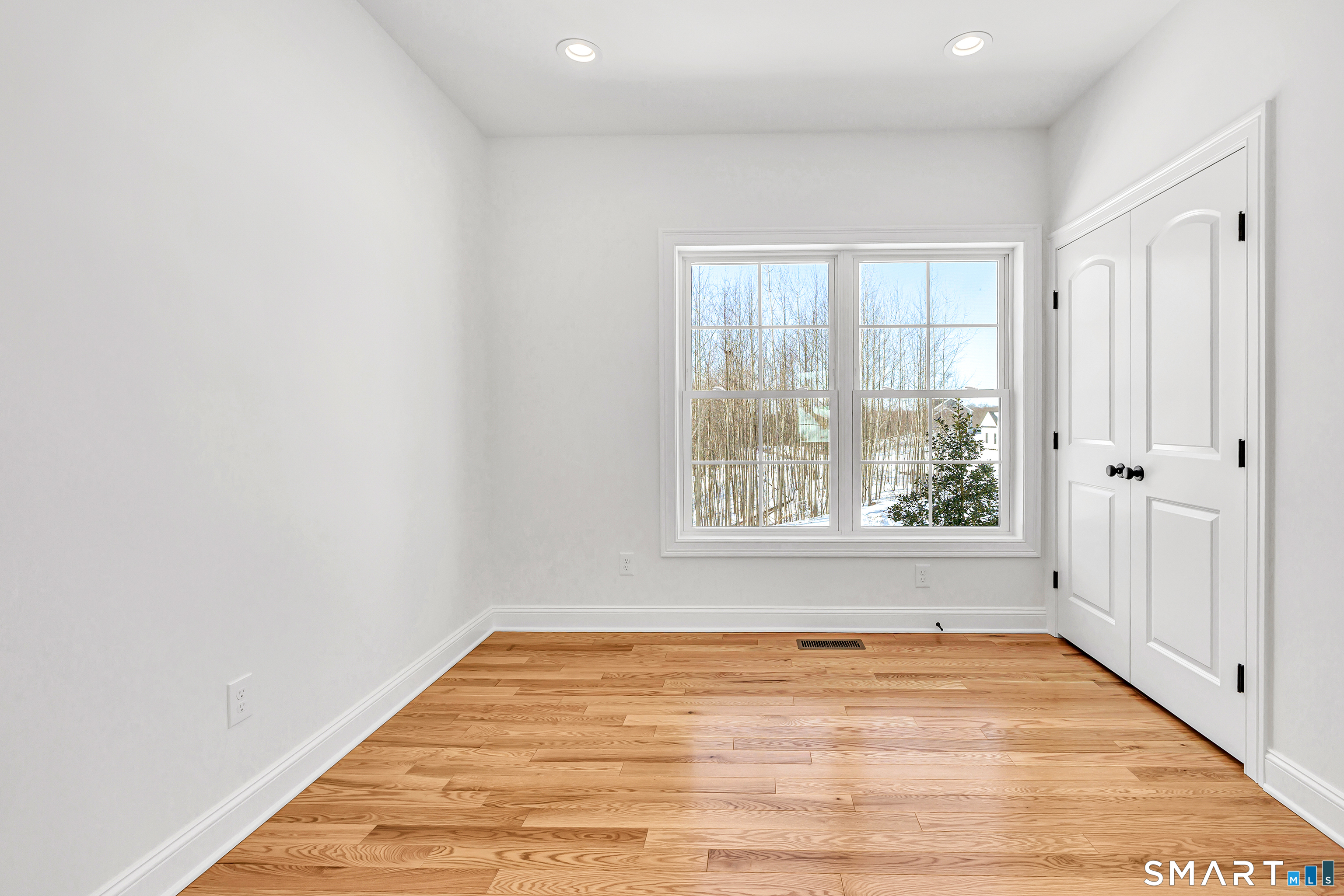 15 Hunting Ridge Road Middlebury, CT 06762 - Photo 8 of 38 an empty room with wooden floor and windows