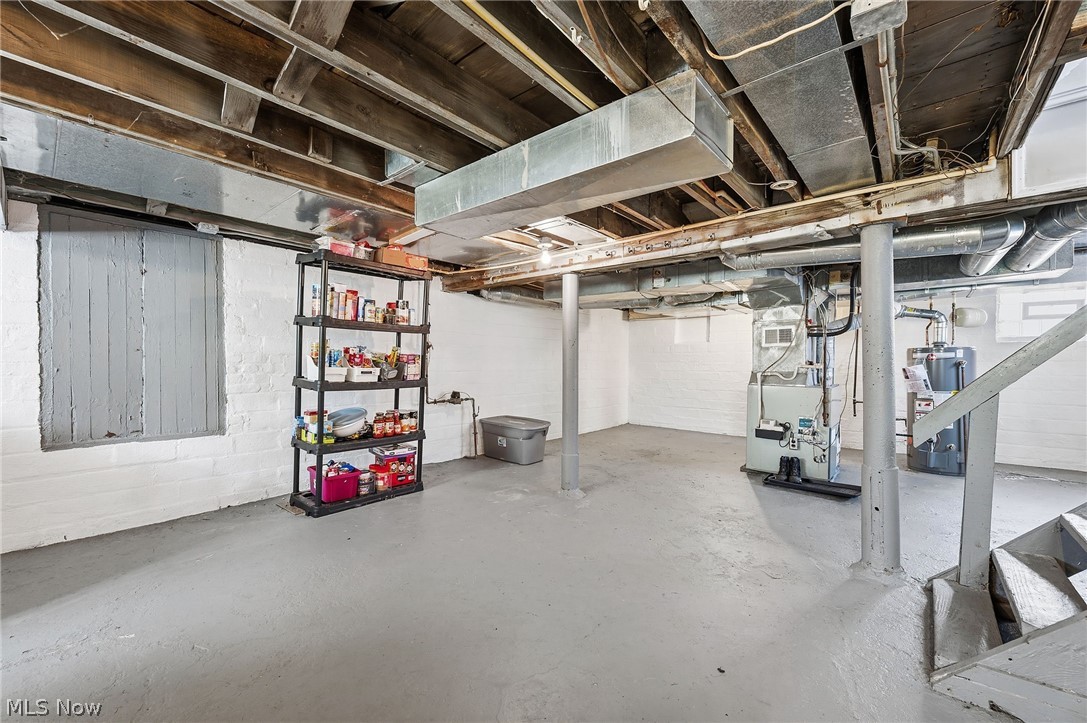 3386 Sylvanhurst Road Cleveland Heights, OH 44112 - Photo 37 of 46 Spacious basement featuring painted concrete flooring, exposed ceiling joists, and structural support pillars