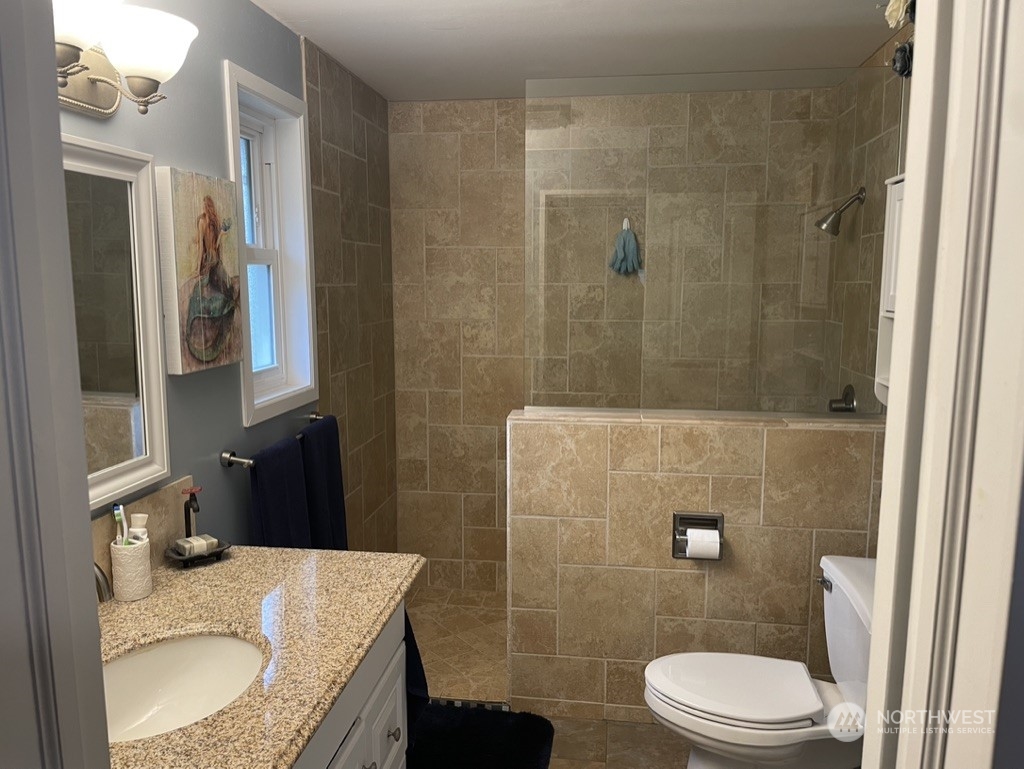 300 Bush Creek Road Elma, WA 98541 - Photo 12 of 21 a bathroom with a granite countertop sink toilet and shower
