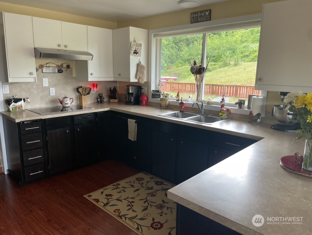 300 Bush Creek Road Elma, WA 98541 - Photo 7 of 21 a kitchen with sink a window and cabinets