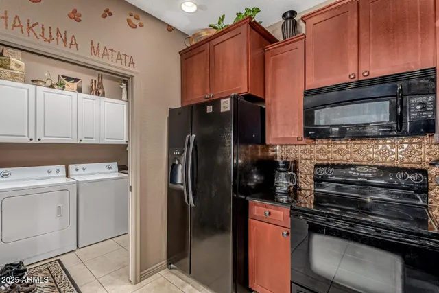 a kitchen with stainless steel appliances and wood cabinets