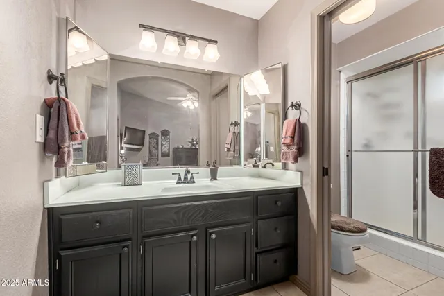a bathroom with a double vanity sink mirror and toilet
