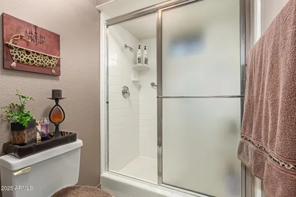a bathroom with a shower toilet and sink