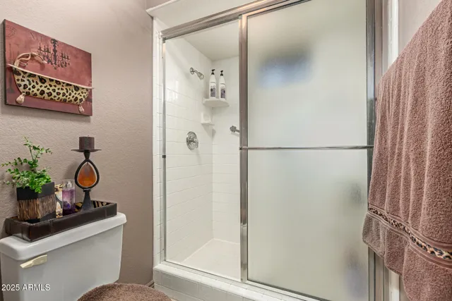a bathroom with a shower toilet and sink