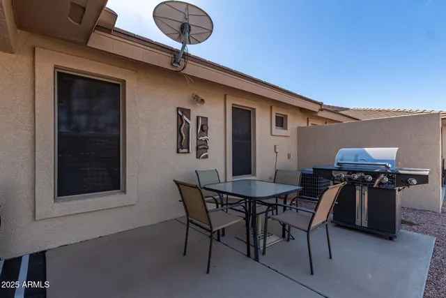 a view of a house with backyard and sitting area
