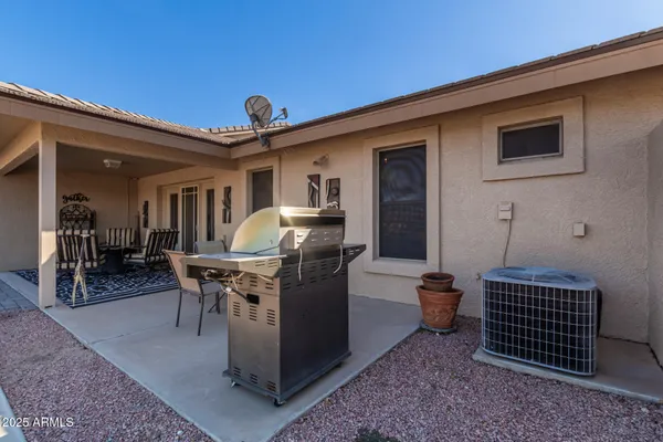 a front view of a house with outdoor seating