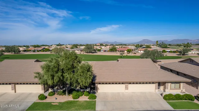 an aerial view of a house with a yard and lake view