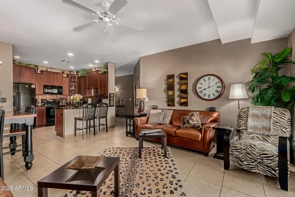 a living room with furniture a clock on wall and a table
