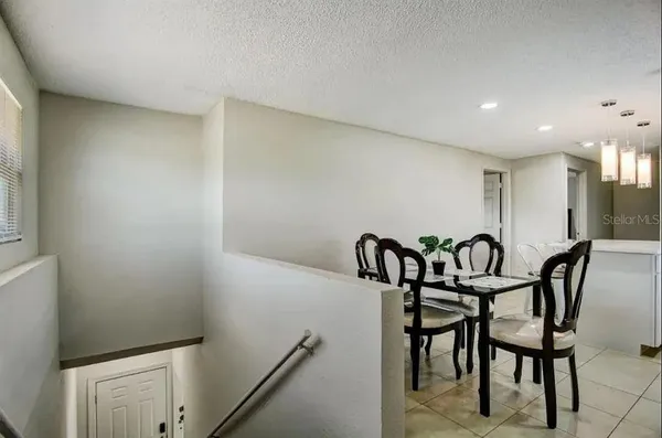 a kitchen with stainless steel appliances granite countertop a sink a microwave a refrigerator and island