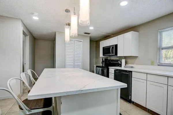 a view of a dining room with furniture and window