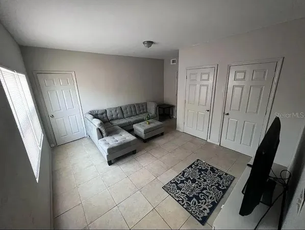 a living room with a couch and a window